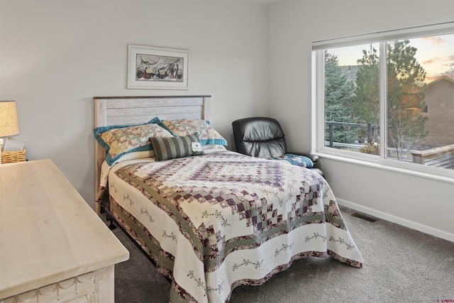 bedroom with carpet floors, visible vents, baseboards, and multiple windows