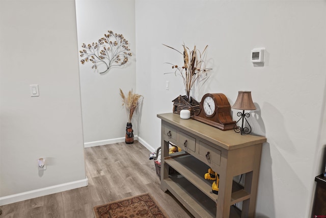 interior space with wood finished floors and baseboards