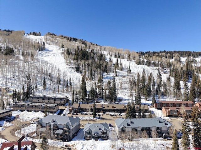 snowy aerial view with a residential view