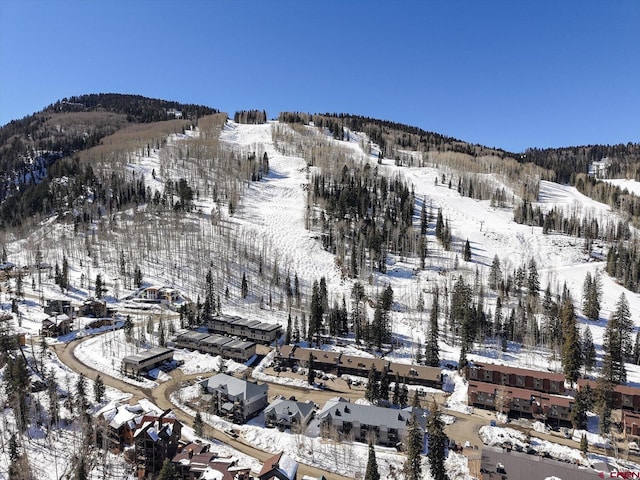 snowy aerial view with a mountain view