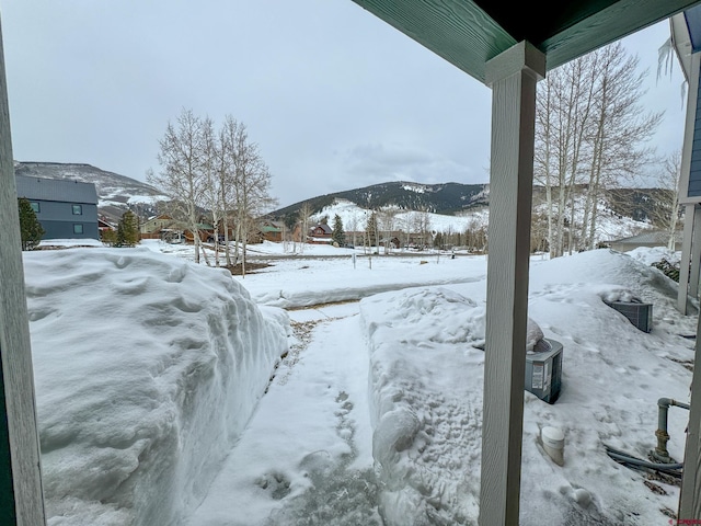 snowy yard with a mountain view