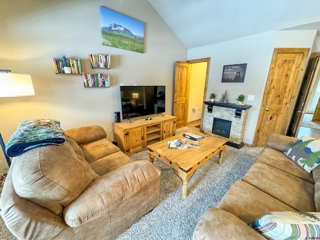 living room featuring high vaulted ceiling and a stone fireplace