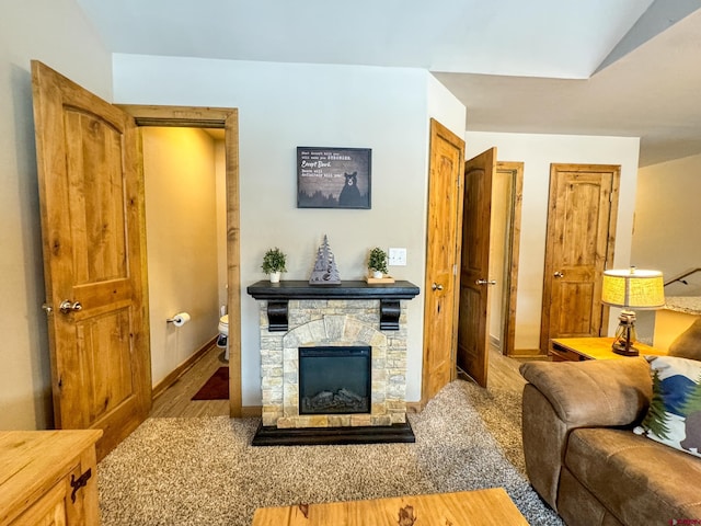 living room with a fireplace, wood finished floors, and baseboards