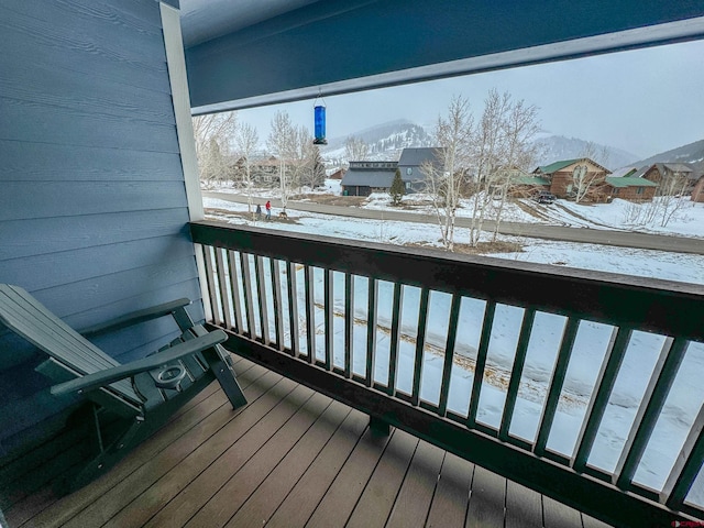 view of snow covered back of property