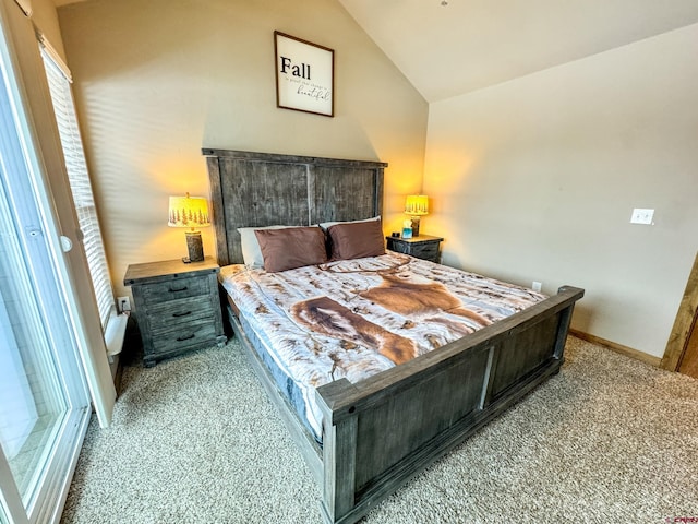 carpeted bedroom with vaulted ceiling and baseboards