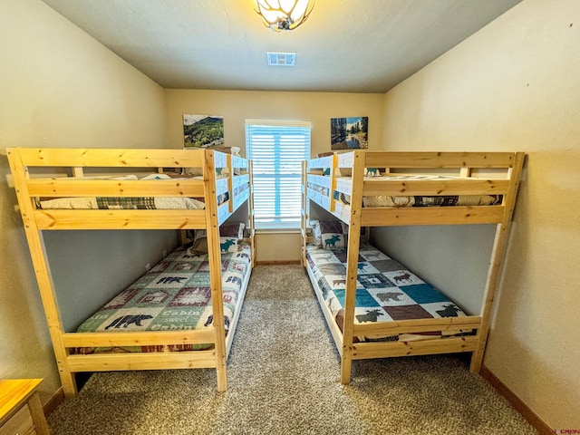 carpeted bedroom featuring visible vents and baseboards