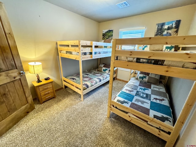 bedroom with carpet floors, visible vents, and baseboards