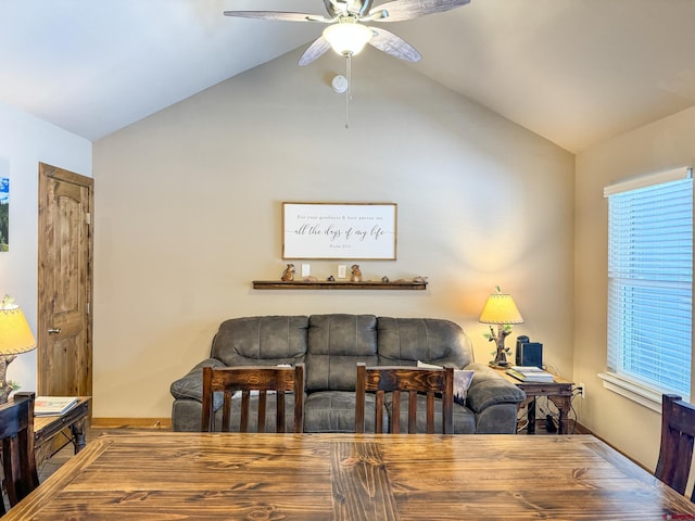 living room with lofted ceiling, ceiling fan, and baseboards