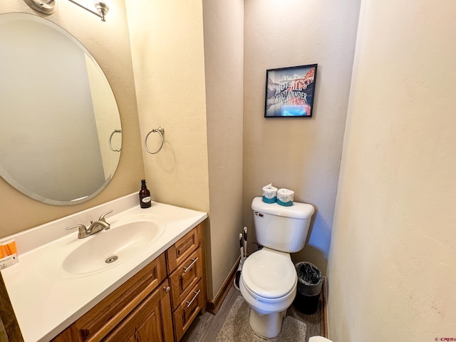 half bath featuring toilet and vanity