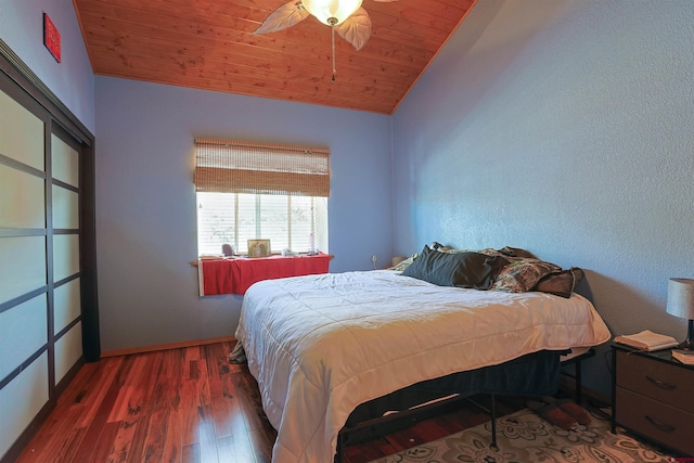 bedroom with ceiling fan, wooden ceiling, wood finished floors, baseboards, and vaulted ceiling