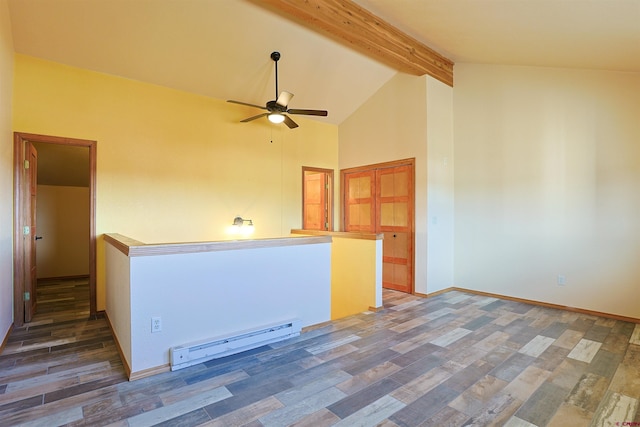 spare room with ceiling fan, baseboard heating, wood finished floors, and beam ceiling