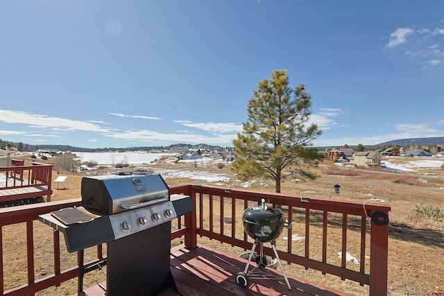 wooden deck featuring a grill