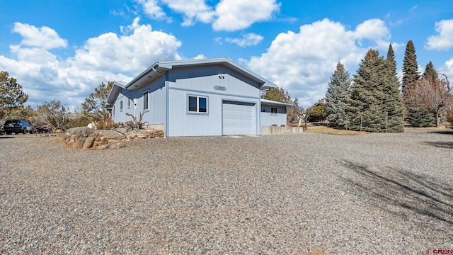 view of side of property with a garage and driveway