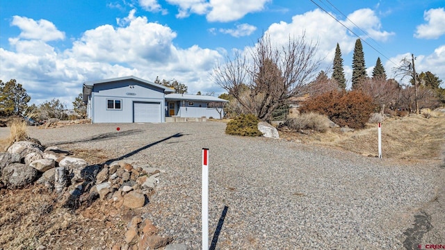 ranch-style home with driveway and an attached garage