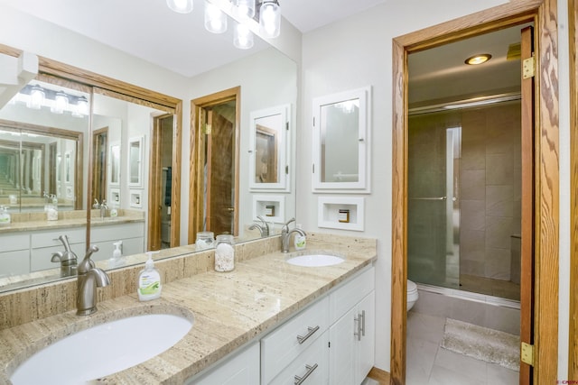 full bathroom featuring a stall shower, a sink, toilet, and double vanity