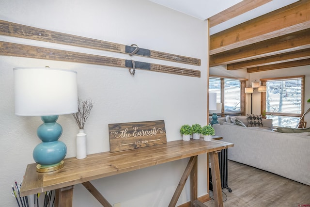 interior space with beamed ceiling and wood finished floors