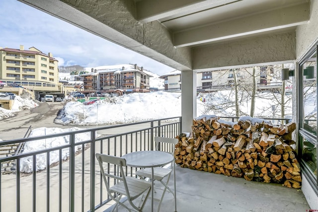 view of snow covered back of property