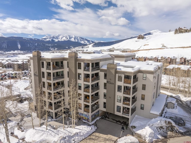 snow covered building with a mountain view