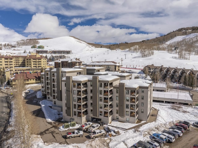 snowy aerial view with a mountain view