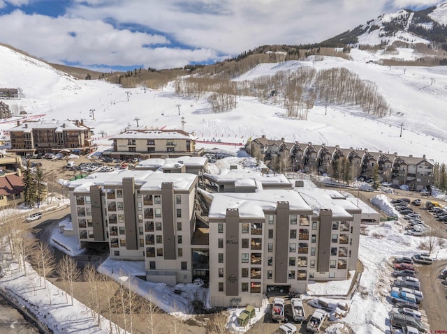 snowy aerial view with a mountain view