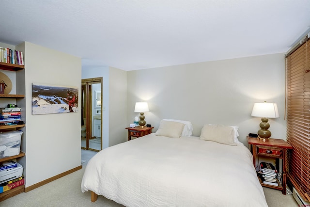 bedroom with light carpet, baseboards, a baseboard heating unit, and a closet