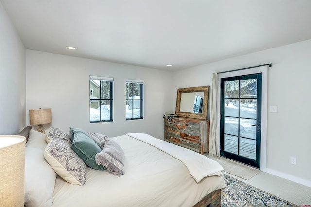 bedroom featuring light carpet, recessed lighting, baseboards, and access to exterior