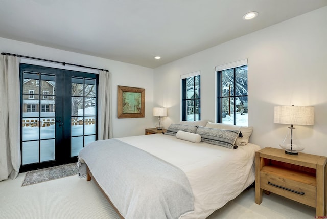 bedroom featuring french doors, recessed lighting, light colored carpet, and access to exterior