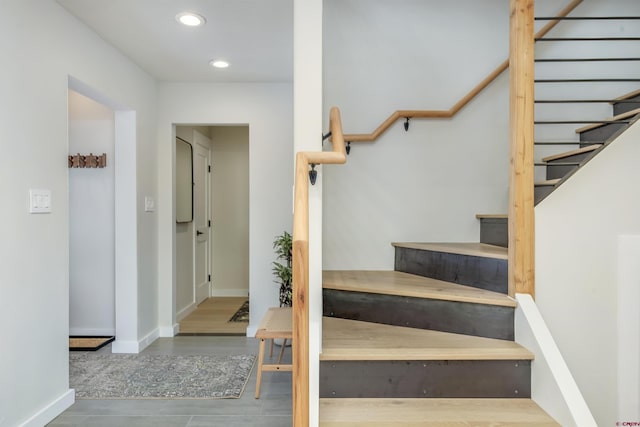 staircase with baseboards and recessed lighting