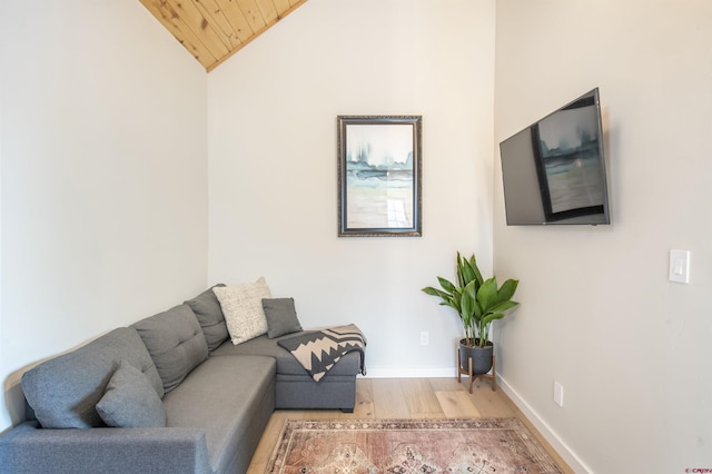 living room featuring lofted ceiling, wooden ceiling, wood finished floors, and baseboards