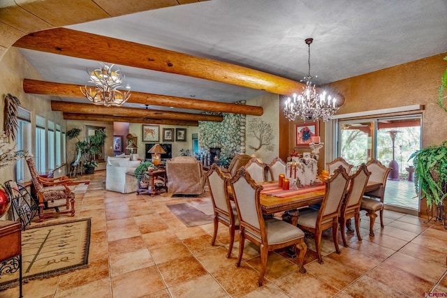 dining room with an inviting chandelier, beam ceiling, and a stone fireplace