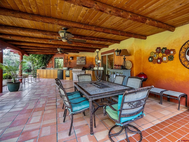 view of patio featuring outdoor dining space, ceiling fan, grilling area, and area for grilling