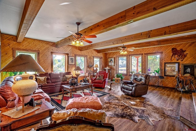 living area with plenty of natural light, beamed ceiling, and wood finished floors