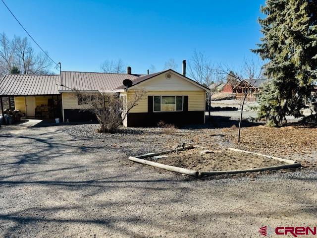 ranch-style house with metal roof