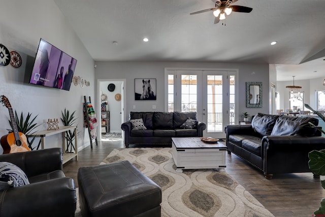 living room with lofted ceiling, recessed lighting, ceiling fan with notable chandelier, french doors, and dark wood finished floors