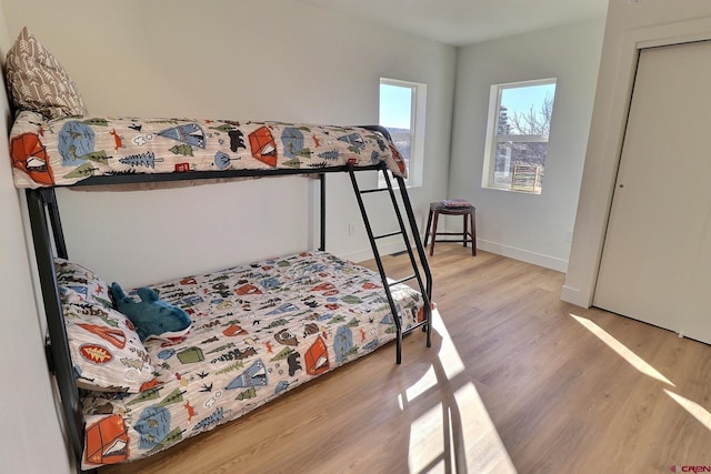 bedroom with wood finished floors and baseboards