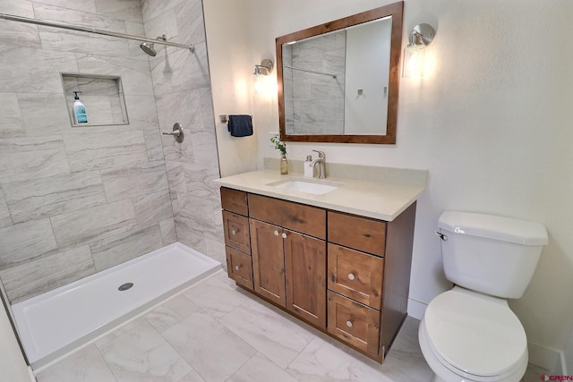 full bathroom featuring marble finish floor, tiled shower, vanity, and toilet