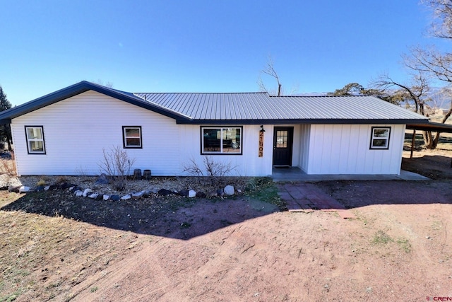 ranch-style house featuring metal roof