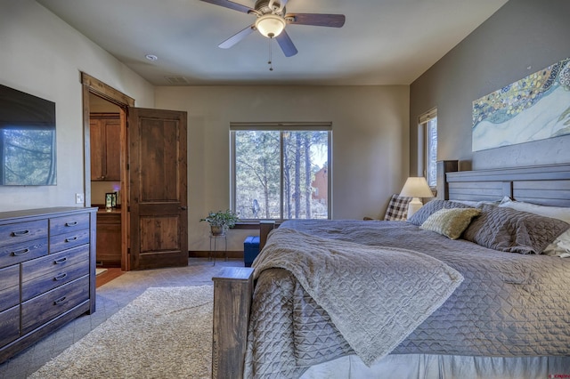 bedroom featuring ceiling fan, visible vents, and baseboards