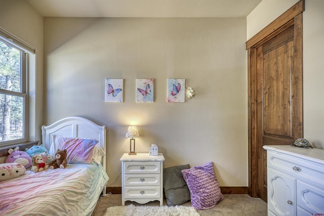 bedroom featuring carpet floors and baseboards