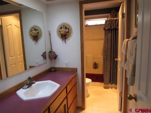 bathroom with toilet, shower / bath combo with shower curtain, vanity, and tile patterned floors