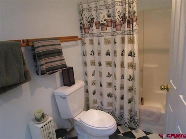 full bath with toilet, shower / bath combo, and tile patterned floors