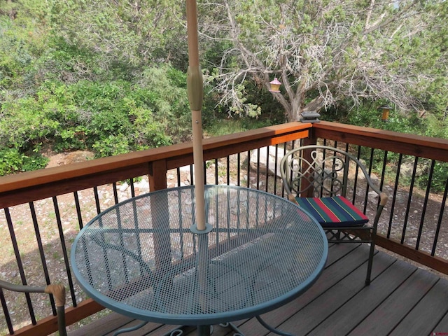 wooden terrace with outdoor dining area