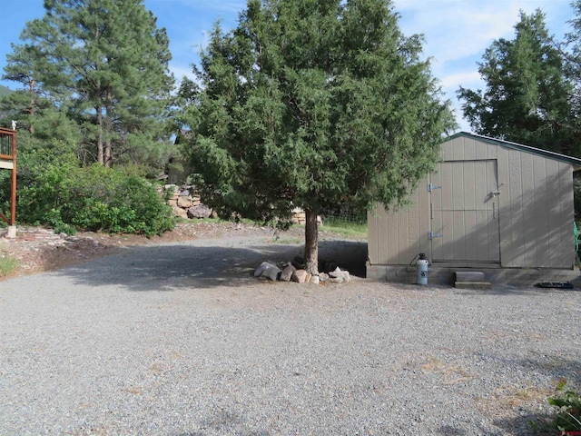 view of yard with a storage unit and an outbuilding