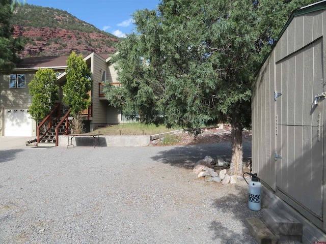 view of yard featuring a mountain view and stairway