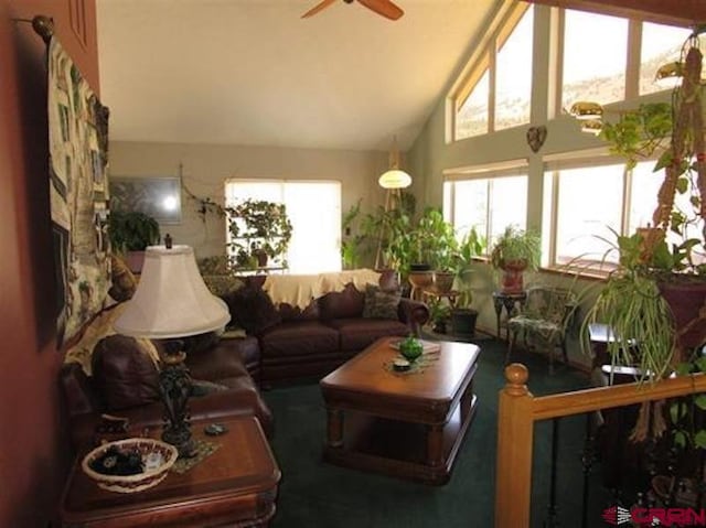 living room featuring high vaulted ceiling and a ceiling fan