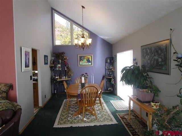 dining area with high vaulted ceiling and a chandelier