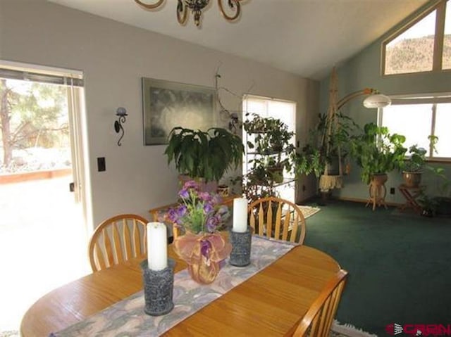 dining room featuring carpet floors and vaulted ceiling