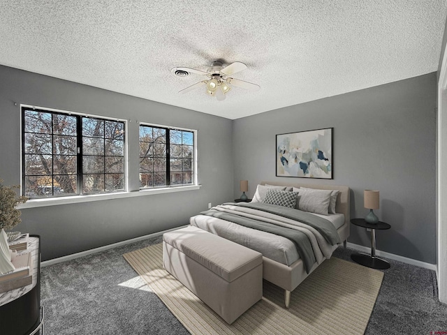 bedroom featuring carpet floors, ceiling fan, baseboards, and a textured ceiling