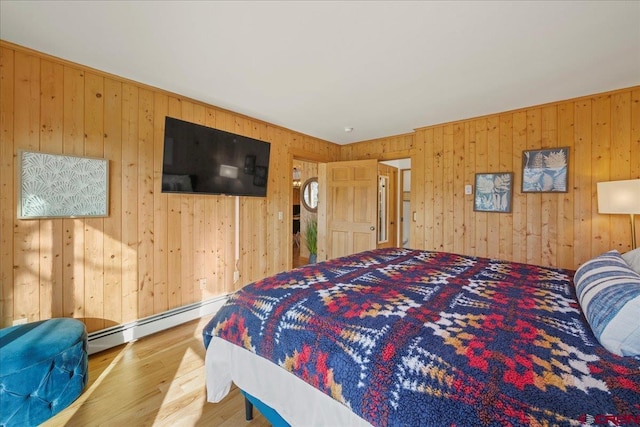 bedroom featuring a baseboard radiator and wood finished floors