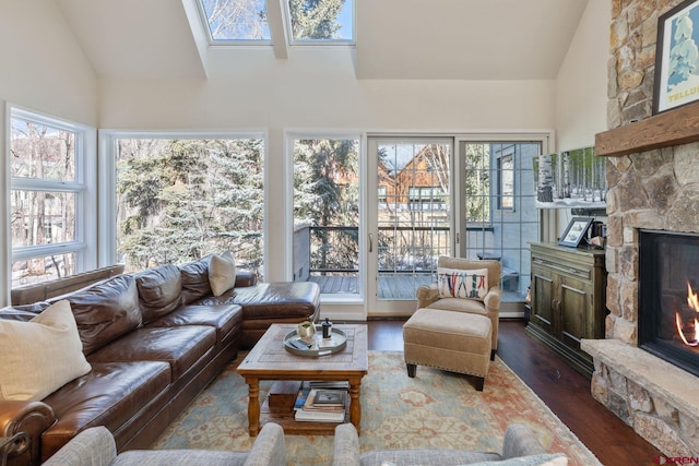 sunroom / solarium featuring lofted ceiling and a fireplace